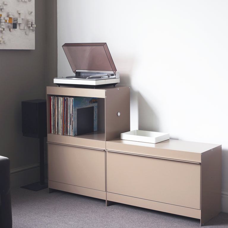 Record player stand and vinyl storage in beige shelving unit