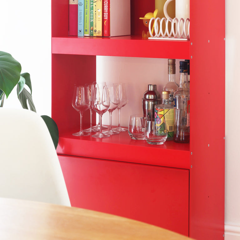 modular shelving unit in red detail with drink bottles and glasses